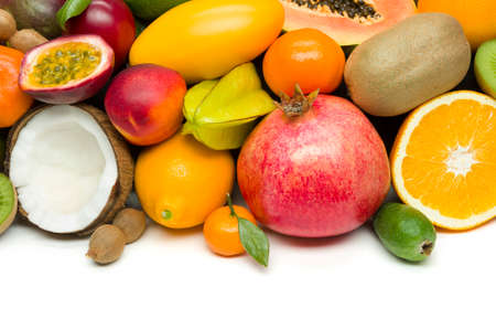 Exotic tropical fruits with slices, healthy food, vegetarian diet, white space for text