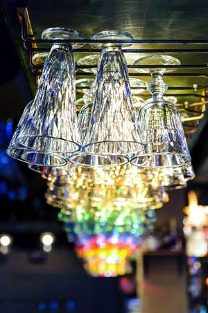 Nightclub faceted empty glasses lit by party bar lights, nightlife entertainment industryの写真素材