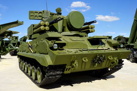 Military combat crawler vehicle with missile launcher, heavy machine gun and mobile antiaircraft...
