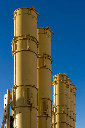 Antiaircraft missile launcher, military ballistic rockets ready to attack, blue sky on background, modern army industryの写真素材
