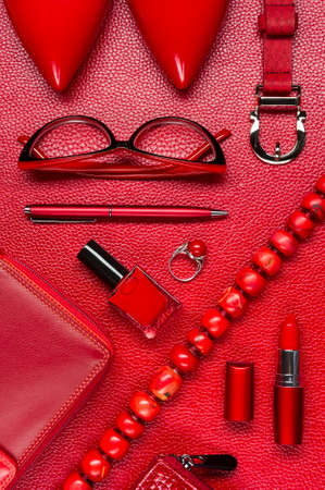Woman red accessories, jewelry, shoes, cosmetic and other luxury objects on leather background, fashion industry, modern female conceptの写真素材