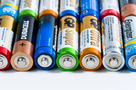 Moscow, Russia - January 05, 2016: Used alkaline batteries AA size format of different brands ready for recycling lying in a rows, studio shot, macrophotography, selective focusのeditorial素材