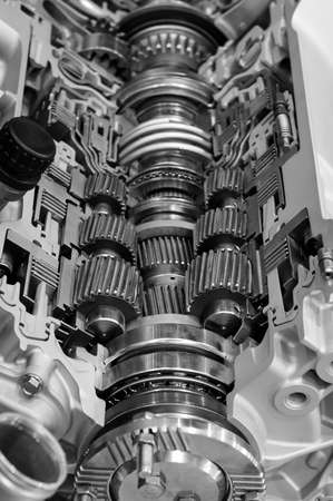 Gear box cross section, engine industry, sprockets, cogwheels and bearings of automotive transmission for oversize trucks and construction vehicles, selective focus, monochrome shotの写真素材
