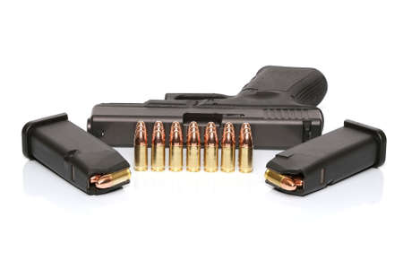 Gun with two magazines and ammoの写真素材