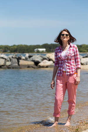 Girl on the beach with stonesの写真素材