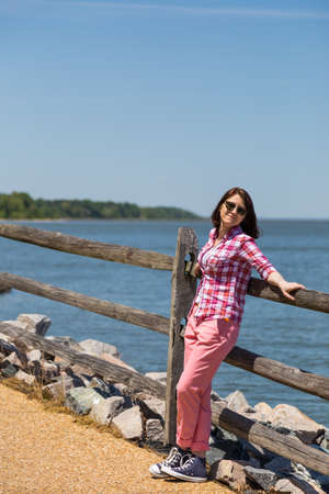 Girl on the beach with stonesの写真素材