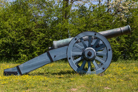 Old blue cannon on green grassの写真素材