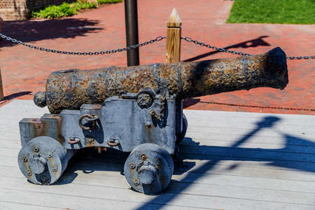Old rusty blue cannon on wooden standの写真素材