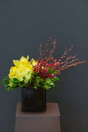 Floral arangement with Cymbidium and James Storey orchids, Hydrangea and greenery in rectangular vaseの写真素材