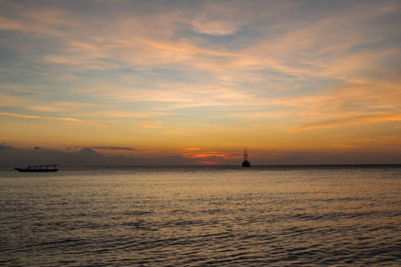 Cruise ship on the sea with sunset over the horizon line