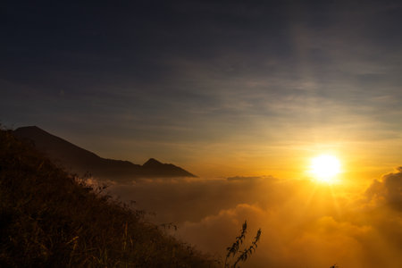 Sunrise over the mountain with expanse of clouds on Mount Anak Dara, Lombok, Indonesia
