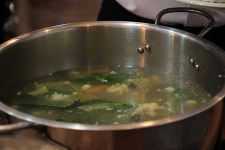 delicious and tasty vegetable soup in a pot on topの写真素材