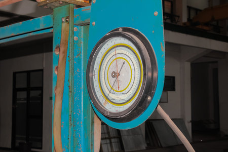 Close-up view of an old industrial force or tension measuring gauge