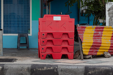 Stacked Safety Barriers - Road Construction Equipment on Sidewalkの写真素材