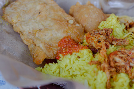 Traditional Yellow Rice dish Nasi Kuning served with various side dishesの写真素材