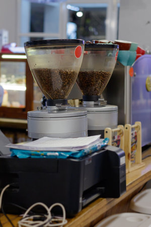 Fresh coffee beans ready for grinding in professional cafe equipment