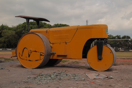 Large yellow road roller machine used for ground compaction and constructionの写真素材
