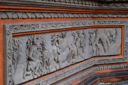 Detailed ancient stone carving artwork showing traditional Balinese mythological scene