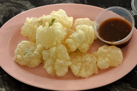 Indonesian Cireng Fried Aci Snack served on a pink plate with dipping chili sauceの写真素材