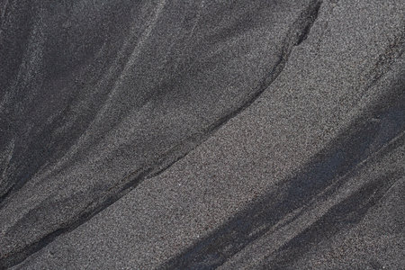 Black Sand Texture Background with Natural Water Erosion Linesの写真素材