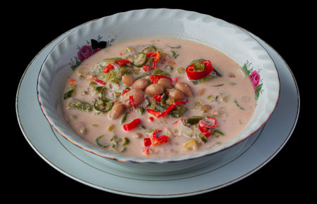 Sayur Ares or Ares Ayam Indonesian traditional Lombok chili coconut soup bowl black background.の写真素材