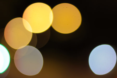 Abstract Bokeh Lights Background with Warm Yellow and Cool Blue Tones for Festive Season and...