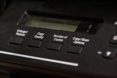 Close-up of black printer control panel with buttons and display for office equipment concepts, emphasizing functionality and user interactionの写真素材