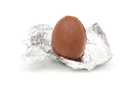 unwrapped chocolate egg in silver foil wrapperの写真素材
