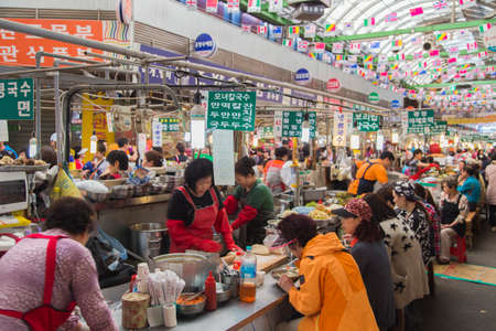 Seoul, Republic of Korea - 5 May 2015: People eating local food on a stall in Gwangjang Market in Seoul, Koreaのeditorial素材