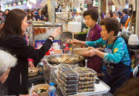 Seoul, Republic of Korea - 5 May 2015: People queing and tasting the food on a stall in Gwangjang Market in Seoul, Koreaのeditorial素材