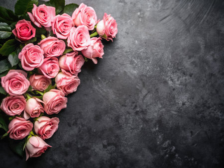 Bouquet of pink roses on dark background. Top view with copy spaceの素材
