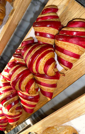 Close up group of fresh baked delicious croissants, super delicious warm fresh buttery Croissants and Rolls, French and American Croissants and baked pastries are enjoyed world wide on bakery shop, tasty multiple croissantの写真素材