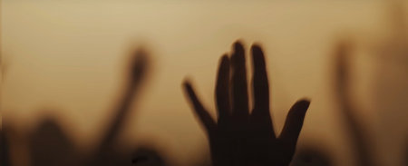 Blurry background picture of hand reaching out for God's help, good for your multimedia content background or card designの写真素材