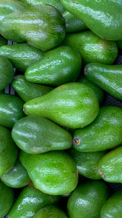 fresh produce of green avocados at the local market, healthy fresh fruit for salad or juice or...