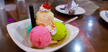 Set of bowls with various colorful Ice Cream scoops with different flavors and fresh ingredients,...