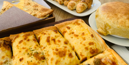 Homemade square pizza with cheese on wooden table Square pizza - Four seasons - Organic pizza - Vegan healthy pizza - Vegetables pizzaの写真素材