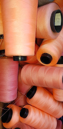 Group of colorful yarn on spool, yarn on tube, cotton, wool, linen thread orange colorful used in...