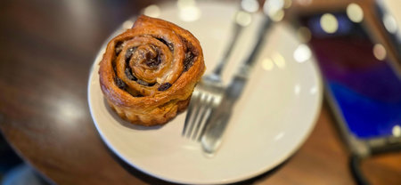 delicious freshly baked Cinnamon rolls or cinnamon bun, with raisins and vanilla also icing sugar...