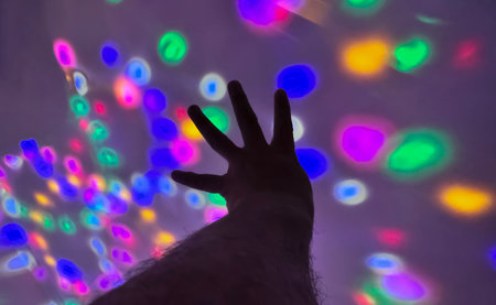 Hand gesture silhouette on a colorful background reaching out, saying hello, and show number represent for multimedia content creationの写真素材