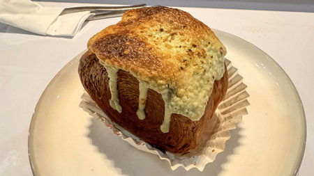 Delicious Cromboloni or Crombolini, croissant bomboloni round New York roll with chocolate sauce or...