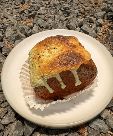 Delicious Cromboloni or Crombolini, croissant bomboloni round New York roll with chocolate sauce or...