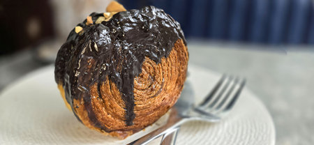 Delicious Cromboloni or Crombolini, croissant bomboloni round New York roll with chocolate sauce or caramel sauce pastry perfect for dessert recipe multimedia content creationの写真素材