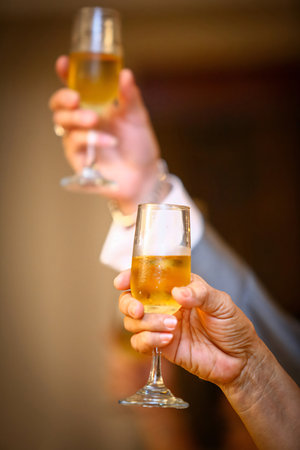 glasses of champagne or wine glasses in a luxurious atmosphere. Drink toast and celebrations, stylish, toned photo, secular reception, new year, wedding, sparkling champagne glasses flutesの写真素材