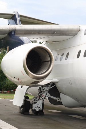 Airplane parks in the airport apron or ramp, business jet plane showing part of its fuselage good...