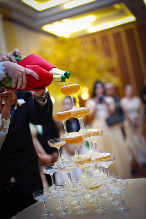 glasses of champagne or wine glasses in a luxurious party atmosphere. Drink toast and celebrations, stylish, toned photo, secular reception, new year, wedding, sparkling champagne glasses conceptの写真素材