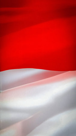 Indonesian flag waving the red and white flag represents symbol of courage and purity, picture the flag of Indonesia with its red symbolizing courage and bravery, and white symbolizing purity and peace good for multimedia content creationの写真素材