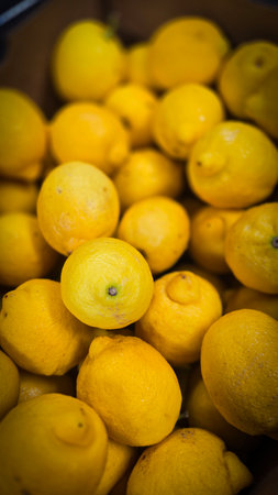 Bright yellow lemons grouped together, presenting an inviting and fresh appearance suitable for culinary or beverage uses, evoking sunny and refreshing vibes. Lemon stack. A vibrant image of fresh, ripe lemons top view. Rich vitamin c, natural and fresh lemon stackの写真素材
