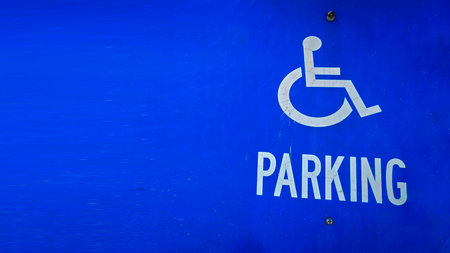blue parking sign featuring a universal symbol for accessibility and the word PARKING. Highlights the availability of designated spaces for differently disabled individuals for convenience. parking symbolの写真素材