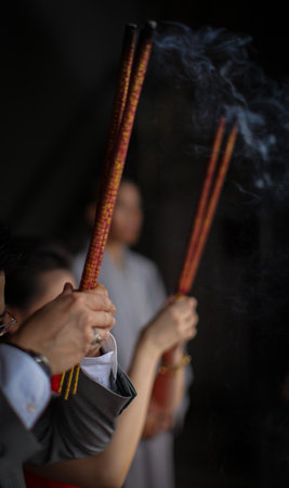 Pray in a Temple as Incense Sticks Burn, Creating a Colorful Ceremonial Scene,Chinese prayer,...