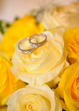 Elegant precious Diamond wedding Rings Resting On Surface With Blurred Backdrop For Wedding ceremonyの写真素材